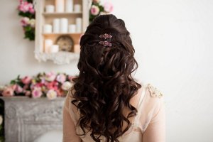 Brunette bride with wavy hair styled in a half updo